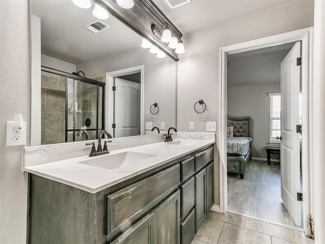 13612 Calabria Trl, Oklahoma City, OK 73170 - ensuite bathroom with double vanity, a shower stall, visible vents, and a sink