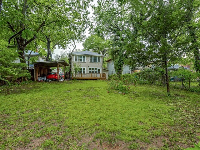 view of yard with fence and a deck