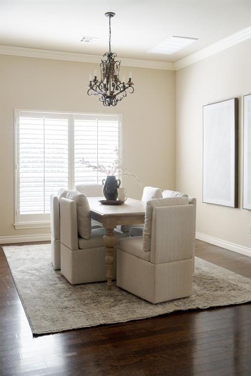 dining area featuring a chandelier, a healthy amount of sunlight, and crown molding