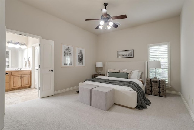 bedroom featuring baseboards, ceiling fan, connected bathroom, and light colored carpet