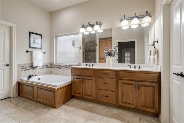 full bath with a sink, tiled shower, a bath, tile patterned floors, and double vanity