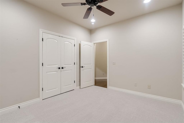unfurnished bedroom featuring a closet, recessed lighting, carpet flooring, and baseboards