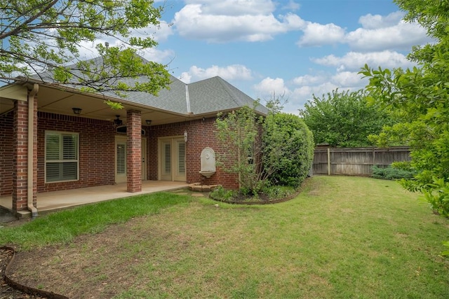view of yard with fence and a patio