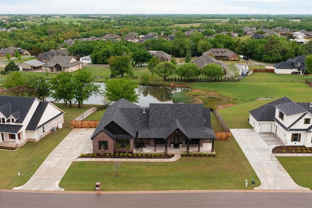 birds eye view of property with a residential view and a water view