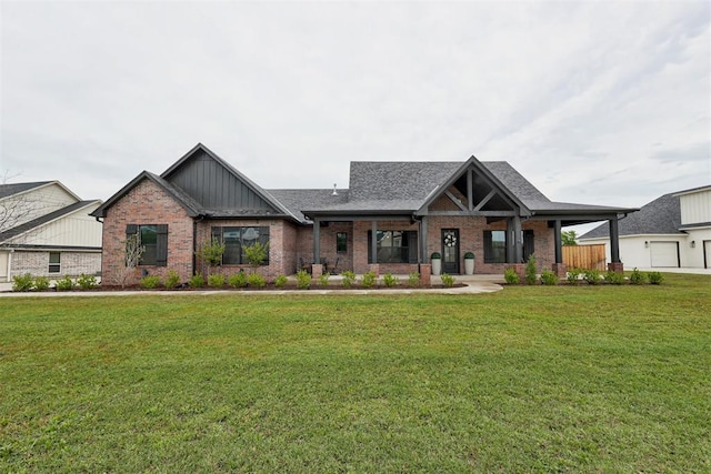 craftsman house featuring a front lawn, board and batten siding, brick siding, and covered porch