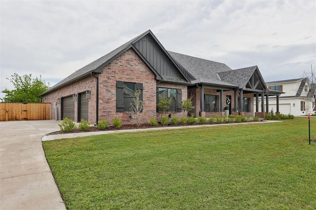 craftsman-style home with concrete driveway, board and batten siding, a front yard, brick siding, and a garage