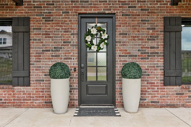 property entrance with brick siding