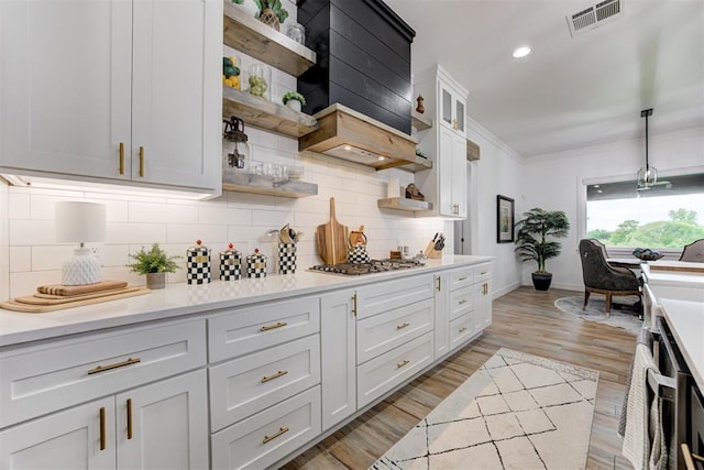 kitchen with baseboards, visible vents, stainless steel gas cooktop, and open shelves
