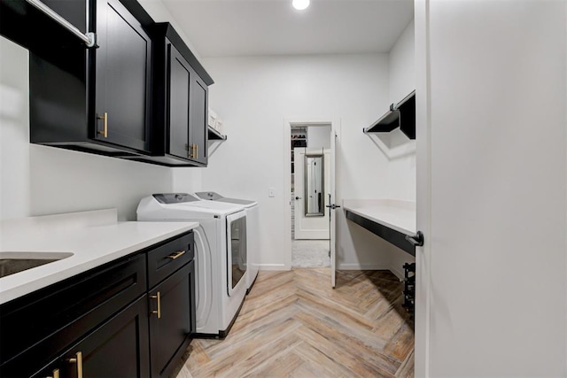laundry room with baseboards, cabinet space, recessed lighting, and washing machine and dryer