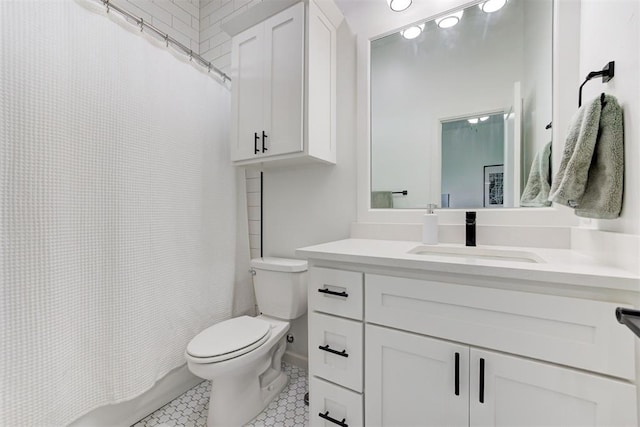 full bath featuring tile patterned floors, vanity, and toilet