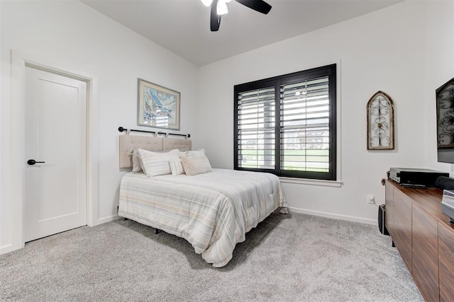 carpeted bedroom featuring a ceiling fan and baseboards