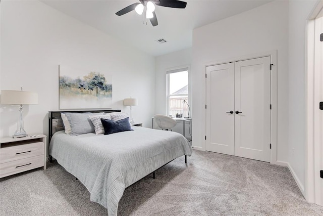 bedroom with a closet, carpet, visible vents, a ceiling fan, and lofted ceiling