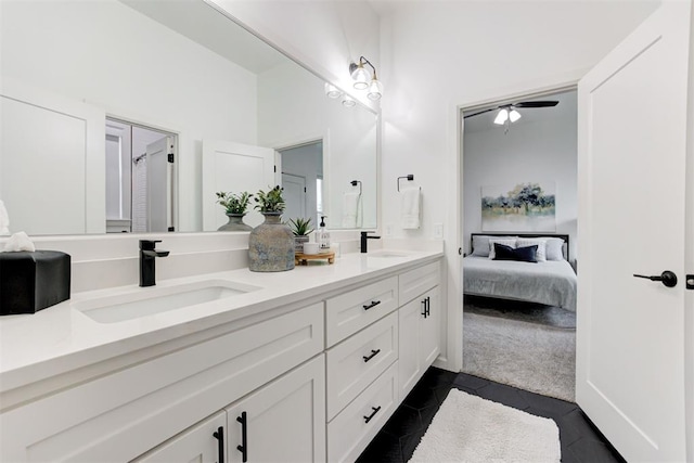 full bath with a sink, a ceiling fan, double vanity, tile patterned flooring, and ensuite bathroom