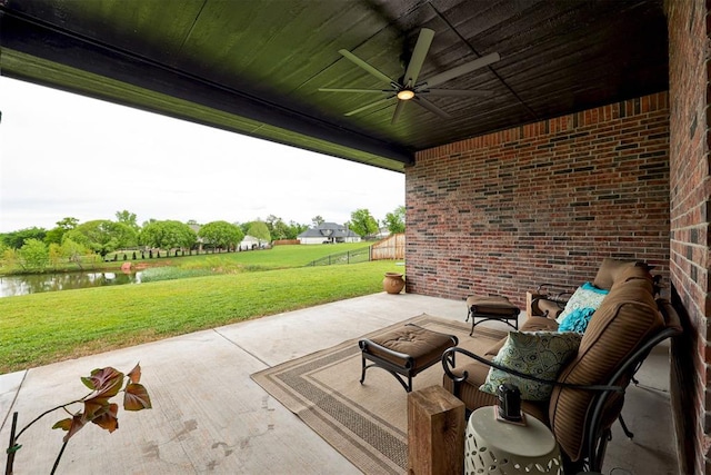 view of patio featuring an outdoor living space, a ceiling fan, and a water view