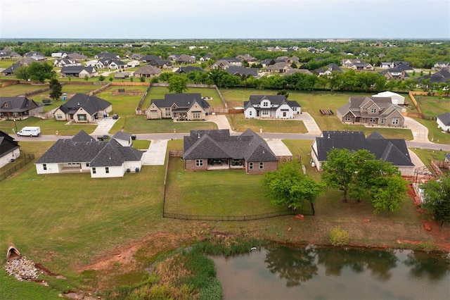drone / aerial view with a residential view and a water view