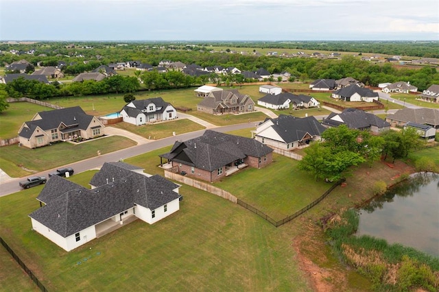 drone / aerial view with a residential view and a water view