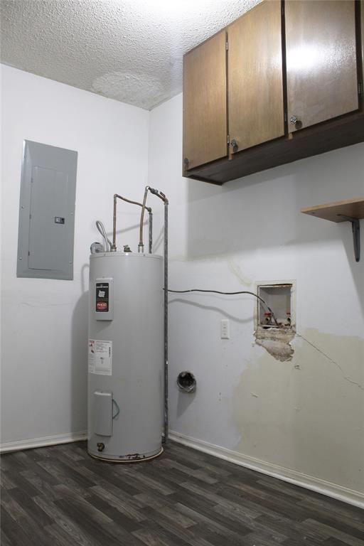 107 S 10th St, Davis, OK 73030 - laundry room featuring electric panel, water heater, cabinet space, dark wood-style floors, and washer hookup