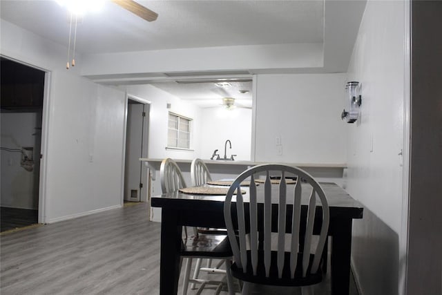 107 S 10th St, Davis, OK 73030 - dining area featuring a ceiling fan, light wood-style flooring, and baseboards