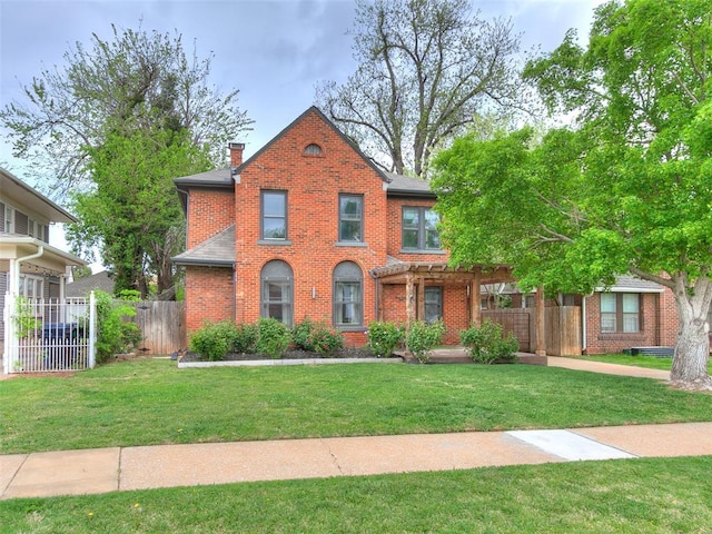 725 NE 15th St, Oklahoma City, OK 73104 - view of front of home with a chimney, brick siding, fence, and a front yard