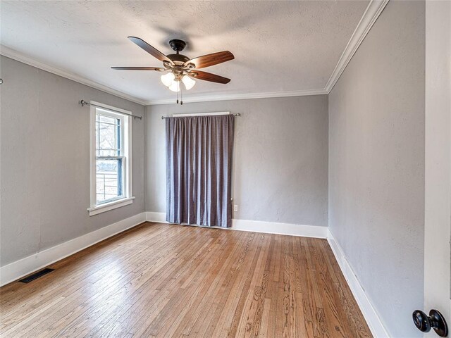 725 NE 15th St, Oklahoma City, OK 73104 - spare room featuring a textured ceiling, hardwood / wood-style flooring, visible vents, ceiling fan, and ornamental molding