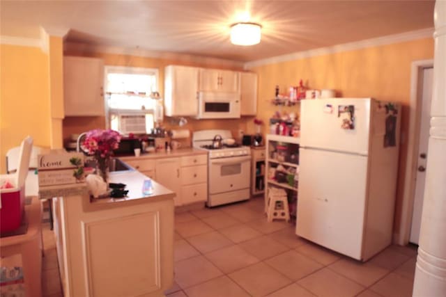 607 E Liveoak St, Altus, OK 73521 - kitchen featuring white appliances, a peninsula, light tile patterned flooring, light countertops, and crown molding