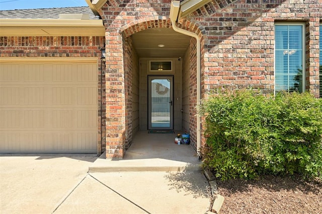 15808 Cantera Creek Dr, Edmond, OK 73013 - property entrance featuring driveway, roof with shingles, an attached garage, and brick siding