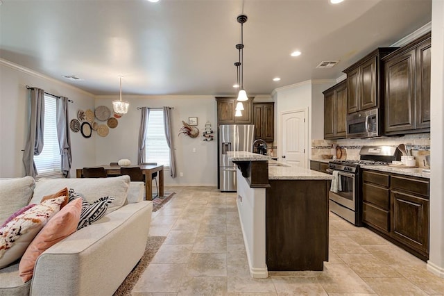 15808 Cantera Creek Dr, Edmond, OK 73013 - kitchen featuring a sink, stainless steel appliances, dark brown cabinetry, ornamental molding, and open floor plan