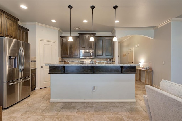 15808 Cantera Creek Dr, Edmond, OK 73013 - kitchen featuring appliances with stainless steel finishes, a center island with sink, ornamental molding, and dark brown cabinetry