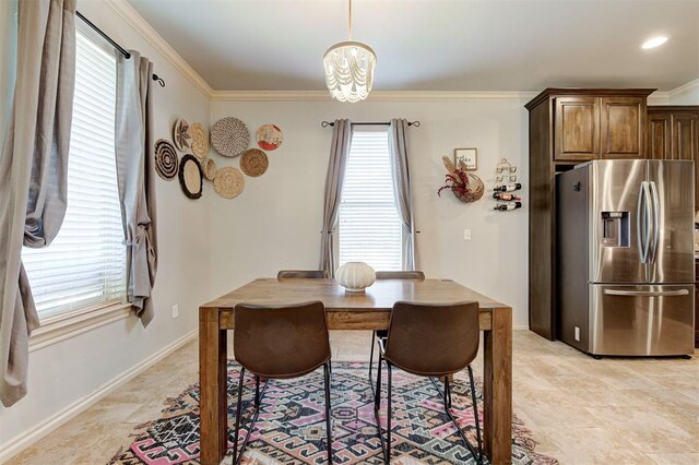 15808 Cantera Creek Dr, Edmond, OK 73013 - dining space with crown molding, an inviting chandelier, and baseboards