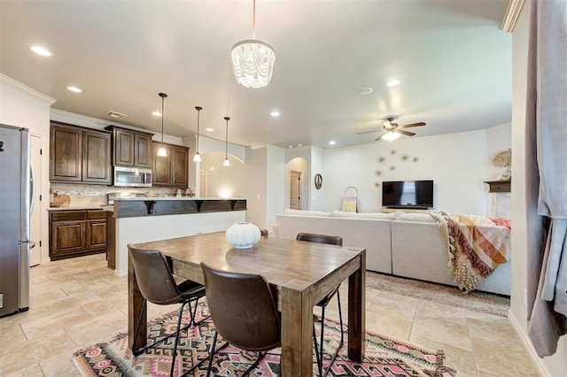 15808 Cantera Creek Dr, Edmond, OK 73013 - dining space featuring recessed lighting, arched walkways, ceiling fan with notable chandelier, and crown molding