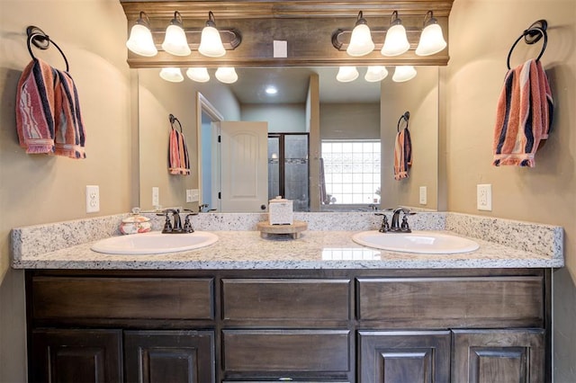 15808 Cantera Creek Dr, Edmond, OK 73013 - bathroom featuring a shower with shower door, double vanity, and a sink