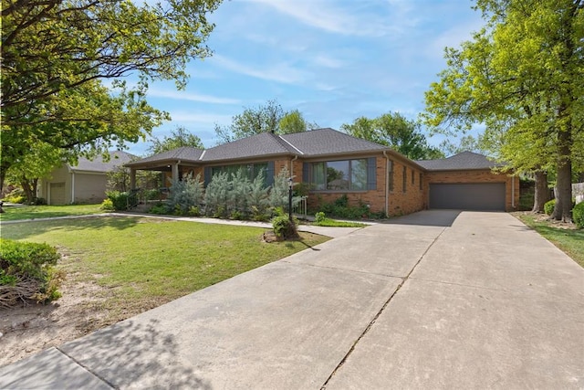 single story home with concrete driveway, brick siding, a garage, and a front yard