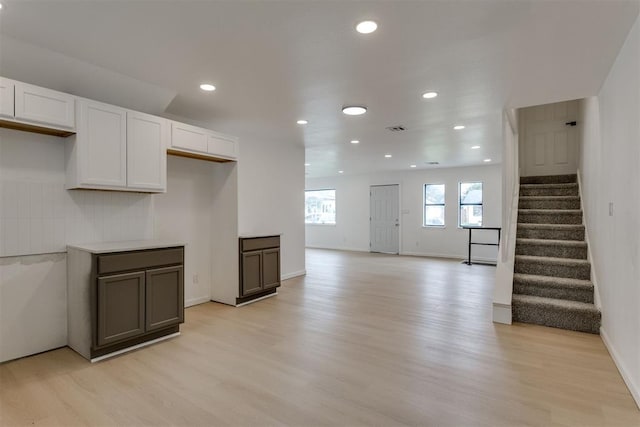 1437 SW 34th St, Oklahoma City, OK 73119 - kitchen featuring visible vents, baseboards, light wood-type flooring, recessed lighting, and white cabinetry