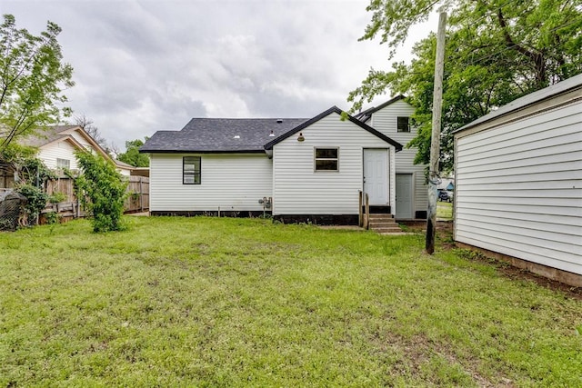 1437 SW 34th St, Oklahoma City, OK 73119 - rear view of property featuring fence, a shingled roof, a lawn, and entry steps