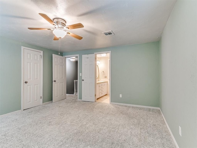 12112 Blue Sage Rd, Oklahoma City, OK 73120 - unfurnished bedroom with light colored carpet, baseboards, visible vents, and ensuite bath