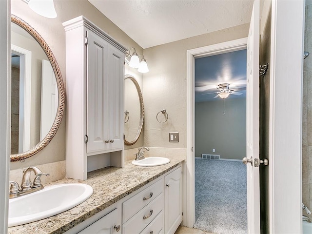 12112 Blue Sage Rd, Oklahoma City, OK 73120 - full bath featuring visible vents, a sink, a ceiling fan, and double vanity