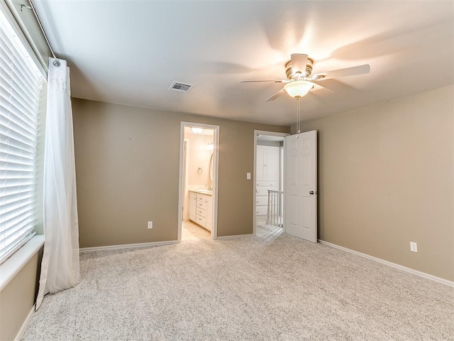 12112 Blue Sage Rd, Oklahoma City, OK 73120 - unfurnished bedroom with visible vents, baseboards, multiple windows, and light colored carpet