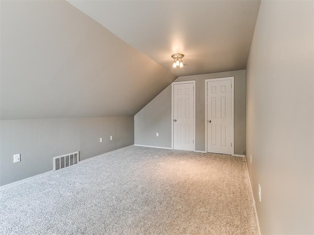 12112 Blue Sage Rd, Oklahoma City, OK 73120 - additional living space with carpet floors, baseboards, lofted ceiling, and visible vents