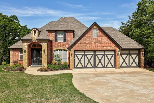 2051 Vaquero Ct, Edmond, OK 73034 - view of front of property with concrete driveway, a front yard, a garage, brick siding, and roof with shingles