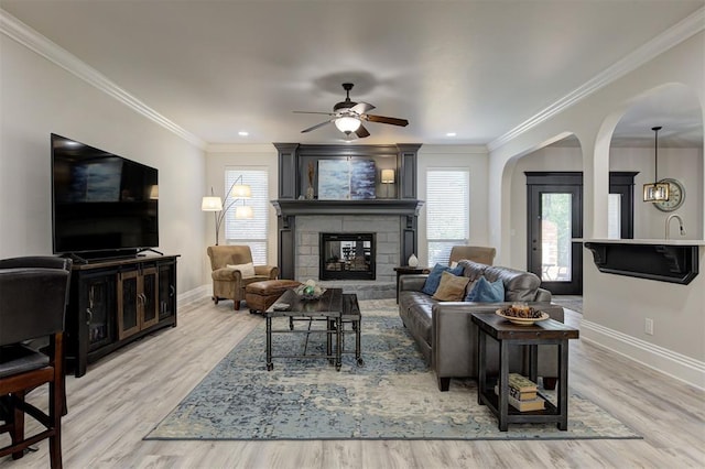 2051 Vaquero Ct, Edmond, OK 73034 - living room featuring arched walkways, baseboards, and a wealth of natural light