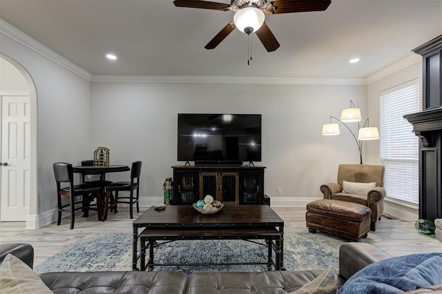 2051 Vaquero Ct, Edmond, OK 73034 - living area with arched walkways, wood finished floors, baseboards, and ceiling fan