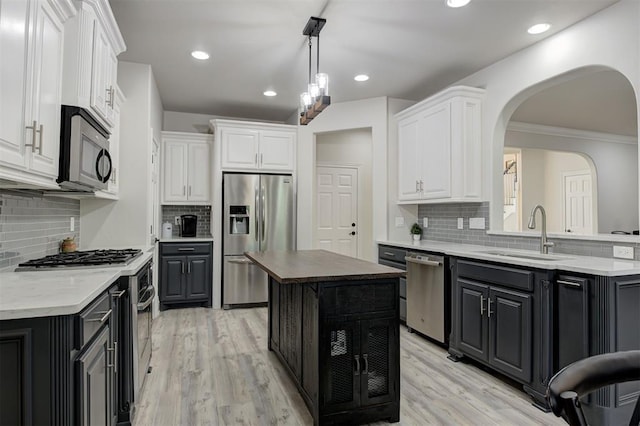 2051 Vaquero Ct, Edmond, OK 73034 - kitchen with tasteful backsplash, white cabinetry, stainless steel appliances, and a sink