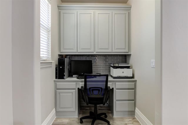 2051 Vaquero Ct, Edmond, OK 73034 - office space featuring light wood finished floors, baseboards, and built in study area