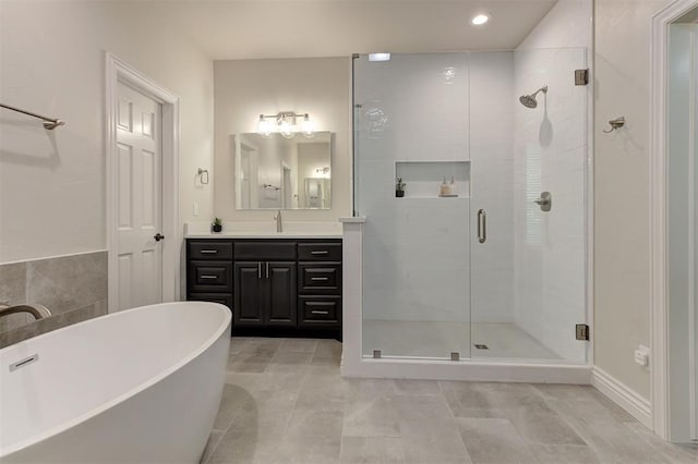 2051 Vaquero Ct, Edmond, OK 73034 - full bath with a shower stall, a soaking tub, vanity, and recessed lighting