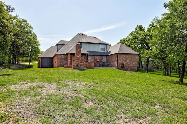 2051 Vaquero Ct, Edmond, OK 73034 - exterior space featuring brick siding, a lawn, a shingled roof, and fence