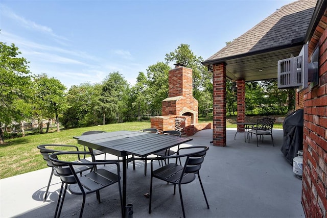 2051 Vaquero Ct, Edmond, OK 73034 - view of patio with outdoor dining area and an outdoor brick fireplace