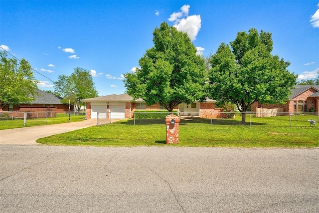 view of front of home featuring a fenced front yard, brick siding, a garage, driveway, and a front lawn