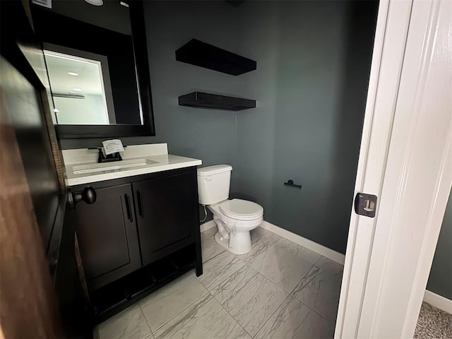 bathroom with vanity, marble finish floor, baseboards, and toilet