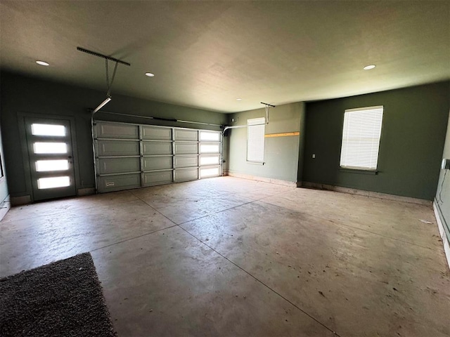garage with baseboards and recessed lighting
