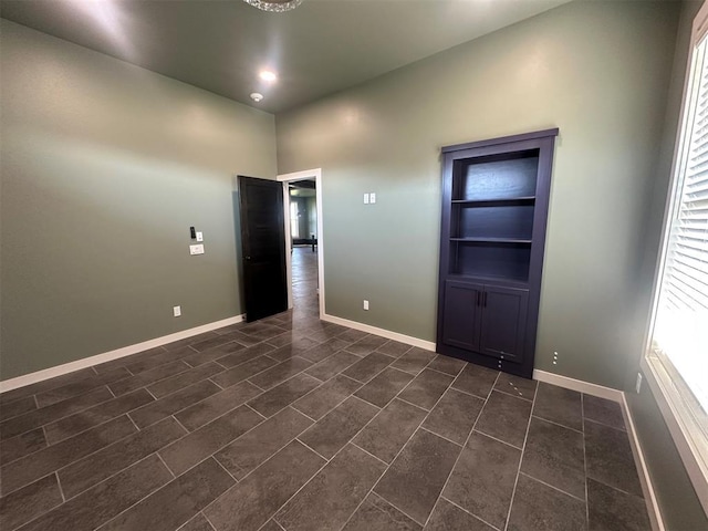 4140 Peony Cir, Piedmont, OK 73078 - empty room featuring built in shelves and dark tile patterned floors
